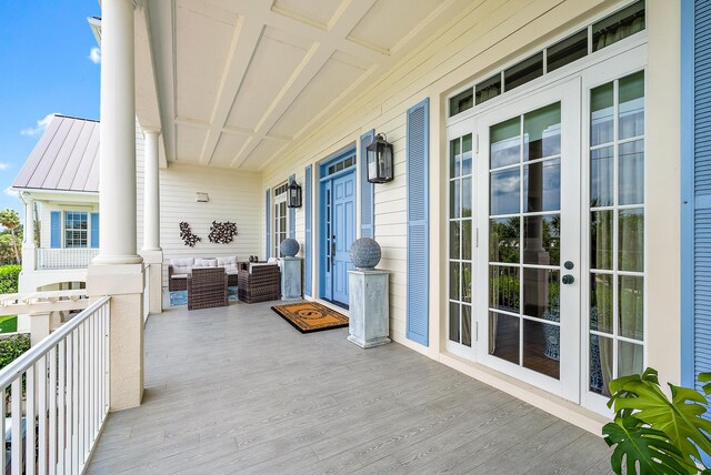 living room featuring ornamental molding, built in features, hardwood / wood-style floors, and an inviting chandelier