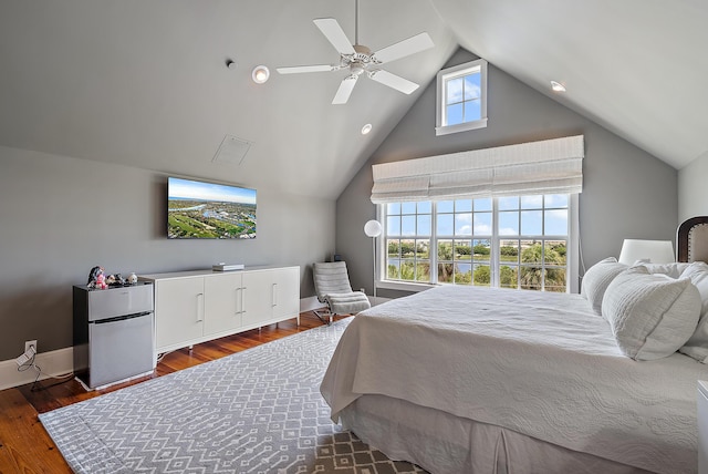 bedroom with stainless steel refrigerator, ceiling fan, and dark wood-type flooring