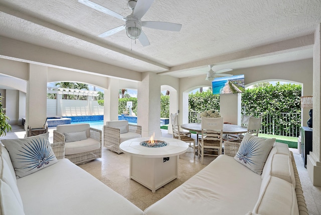 exterior space featuring ceiling fan and a textured ceiling