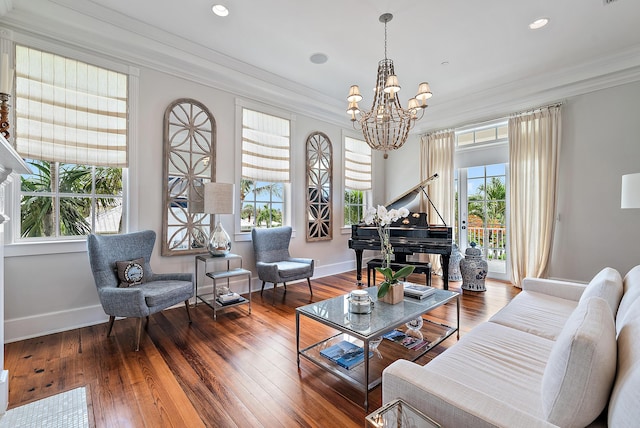 living room with crown molding, a chandelier, and hardwood / wood-style floors