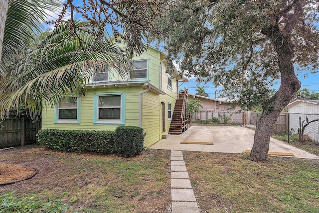 view of property exterior featuring a yard and a patio