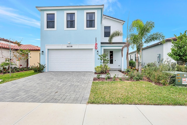 view of front of house featuring a front lawn and a garage