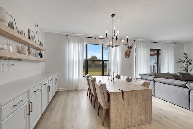 dining area featuring an inviting chandelier and light wood-type flooring