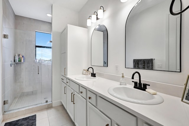 bathroom featuring tile patterned floors, a shower with door, and vanity