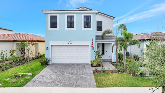 view of front of house featuring a front yard and a garage