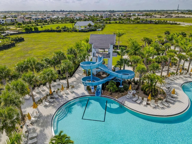 view of pool with a lawn, a pergola, a water slide, and a patio