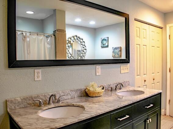 bathroom with tile patterned flooring, vanity, and curtained shower