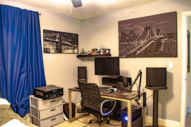 tiled office space featuring ceiling fan and a textured ceiling