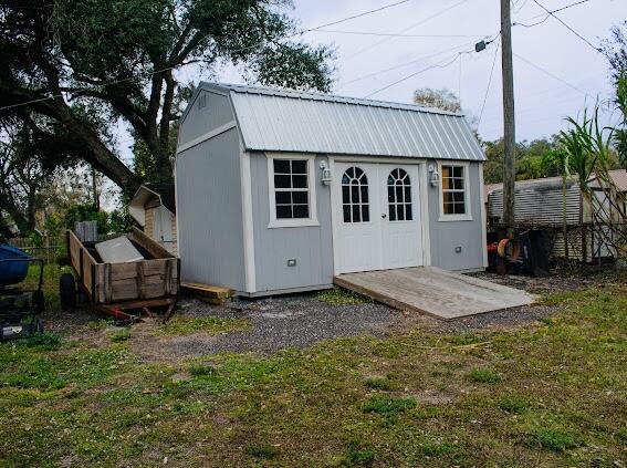 view of outbuilding with a yard