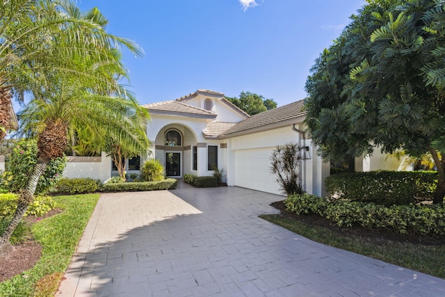 mediterranean / spanish house with a garage