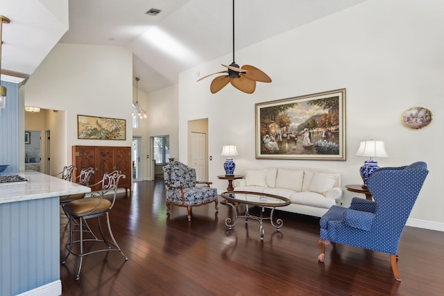 living room featuring dark wood-type flooring, ceiling fan, and high vaulted ceiling