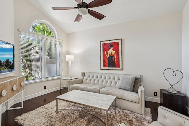 living room with ceiling fan, dark hardwood / wood-style flooring, vaulted ceiling, and a textured ceiling