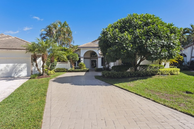 view of front of property with a garage and a front yard