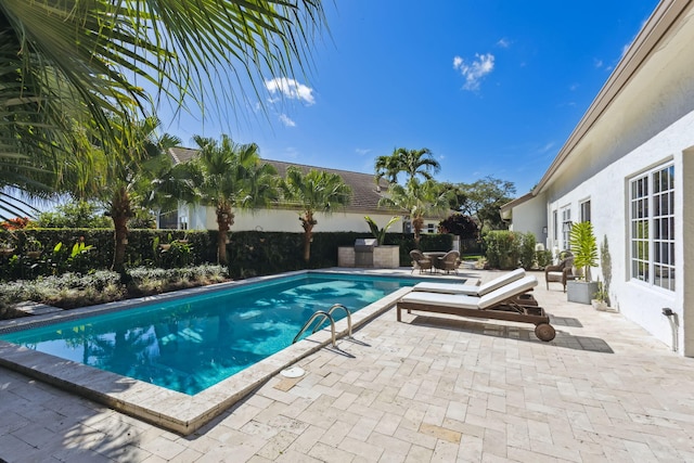 view of pool featuring a patio area