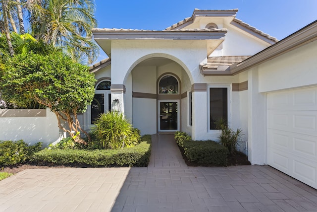 doorway to property with a garage