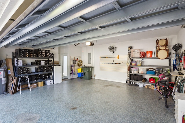 garage with a garage door opener, electric panel, and water heater