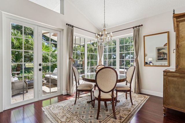 dining space featuring dark hardwood / wood-style flooring, vaulted ceiling, a chandelier, and a textured ceiling