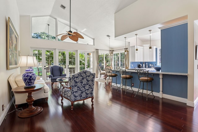 living room featuring dark wood-type flooring, high vaulted ceiling, french doors, and ceiling fan