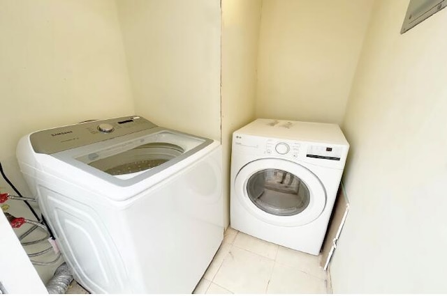 washroom with light tile patterned floors and separate washer and dryer