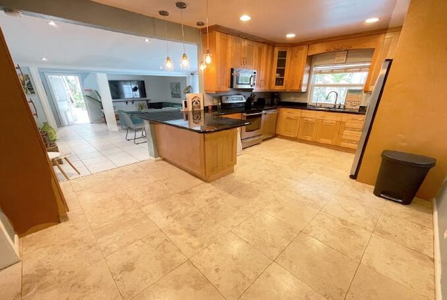 kitchen with decorative light fixtures, a breakfast bar, kitchen peninsula, sink, and stainless steel appliances