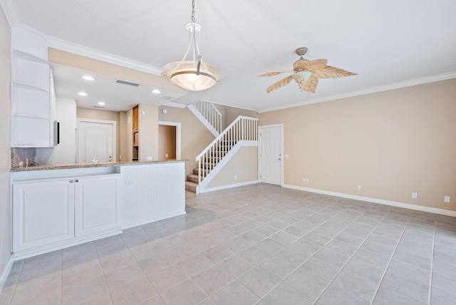 unfurnished living room featuring ceiling fan, ornamental molding, and light tile patterned floors