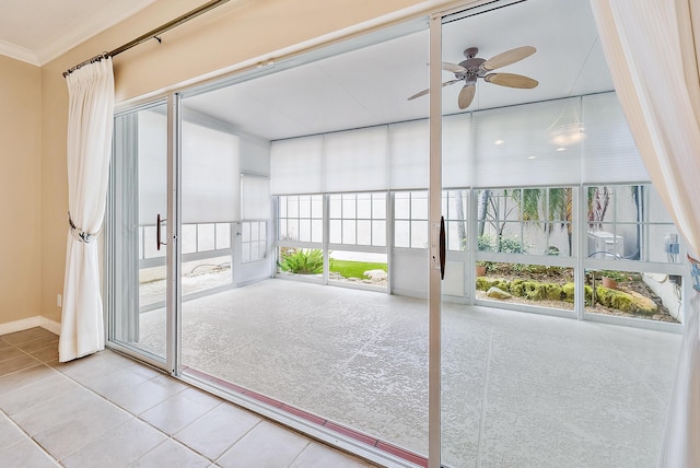 unfurnished sunroom featuring ceiling fan