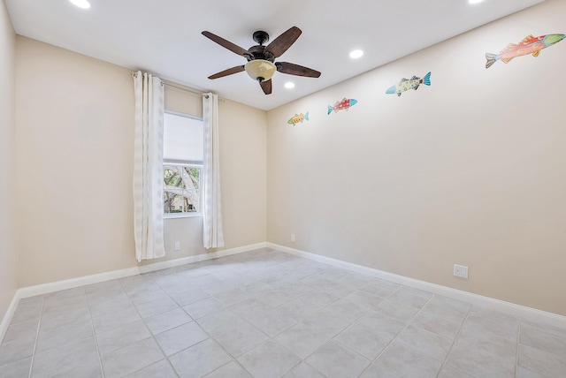 tiled spare room featuring ceiling fan