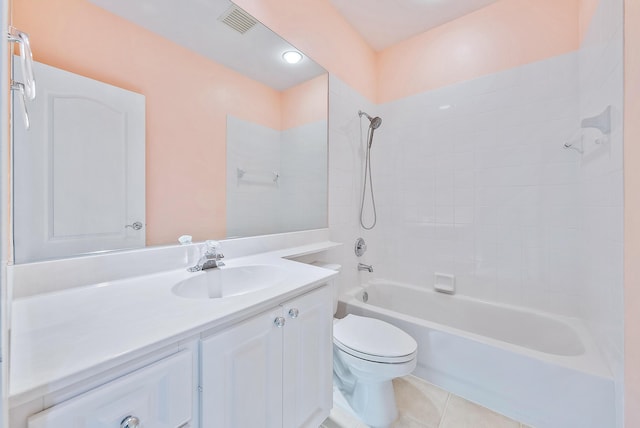 full bathroom featuring tile patterned flooring, tiled shower / bath, vanity, and toilet