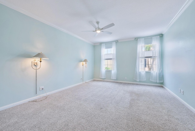 carpeted empty room with a textured ceiling, ornamental molding, and ceiling fan