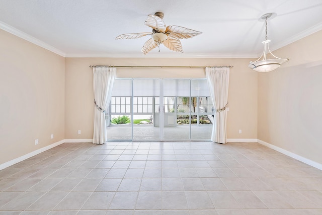 spare room with ceiling fan, ornamental molding, and light tile patterned floors