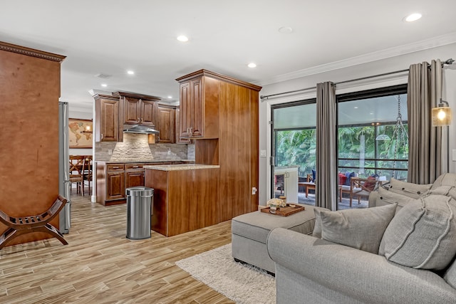 living room featuring ornamental molding and light hardwood / wood-style flooring