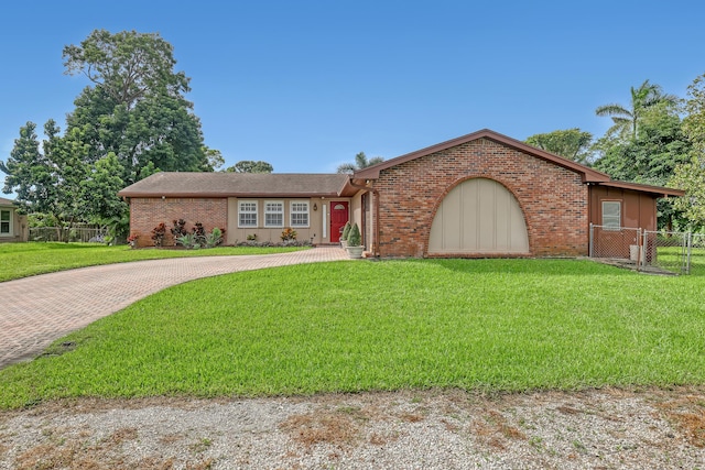 ranch-style home featuring a front yard