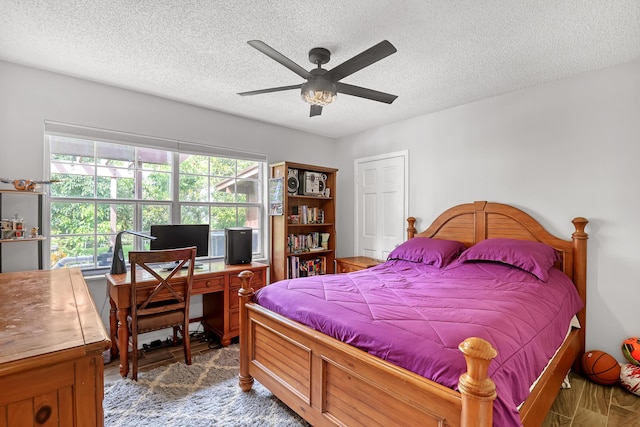 bedroom featuring ceiling fan, a textured ceiling, and hardwood / wood-style floors