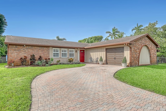 ranch-style house featuring a front lawn and a garage