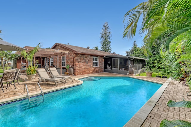 view of swimming pool with a pergola, a sunroom, and a patio