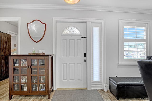 foyer featuring hardwood / wood-style floors and crown molding