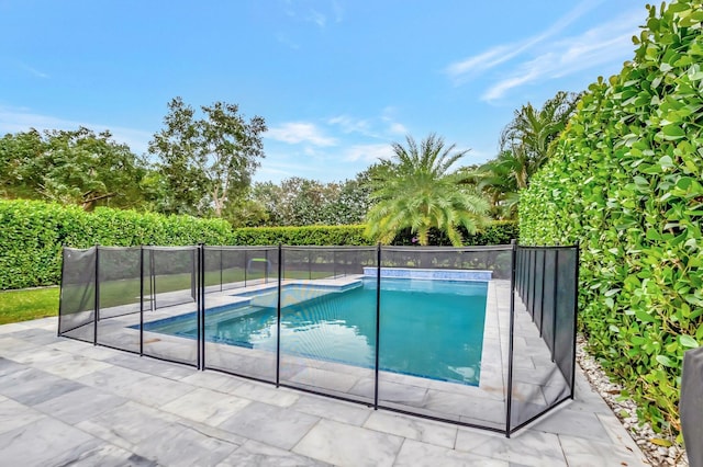 view of swimming pool featuring a patio area, fence, and a fenced in pool