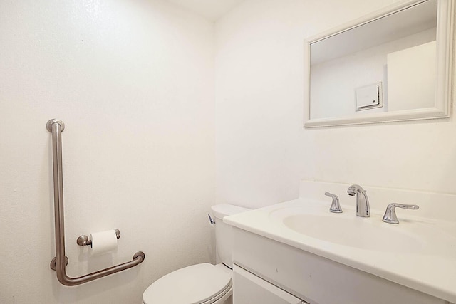 bathroom featuring toilet and vanity