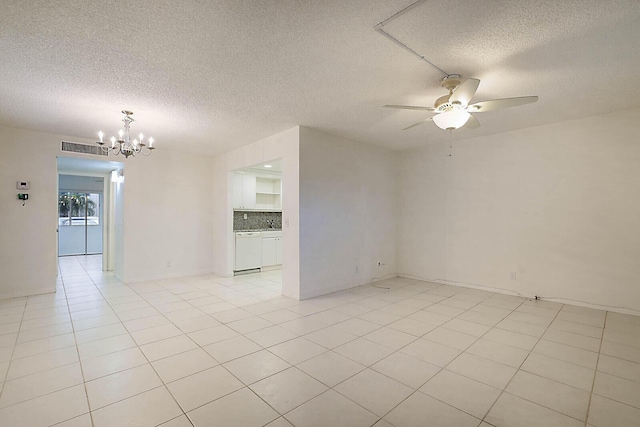 tiled empty room with ceiling fan with notable chandelier and a textured ceiling