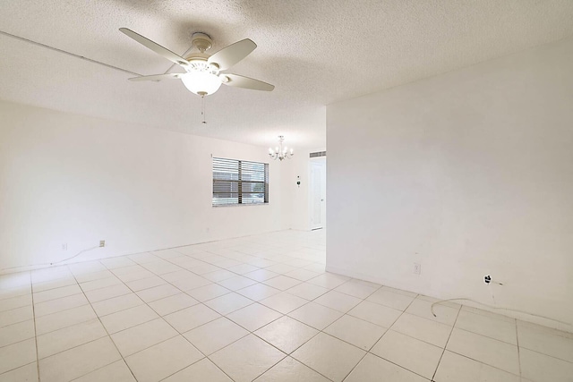 unfurnished room featuring ceiling fan with notable chandelier, a textured ceiling, and light tile patterned floors