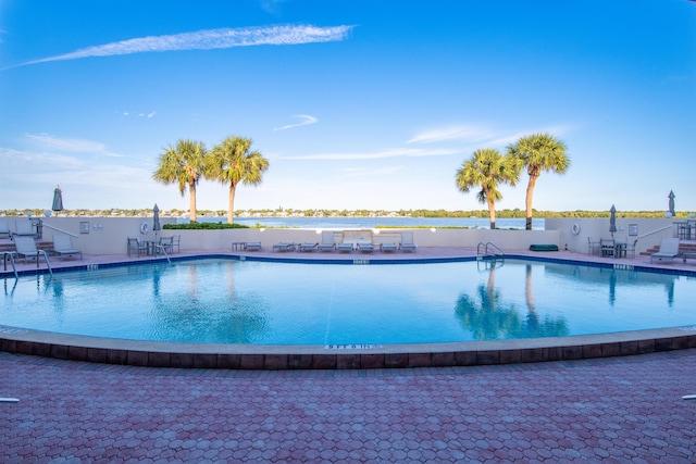 view of swimming pool with a water view