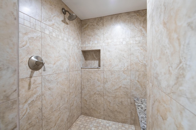 bathroom with a tile shower