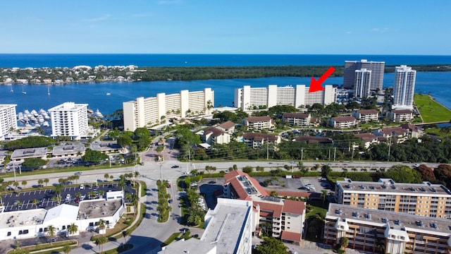 birds eye view of property with a water view and a city view