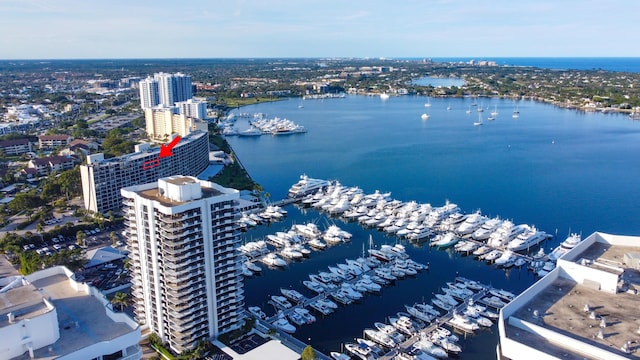 drone / aerial view featuring a view of city and a water view