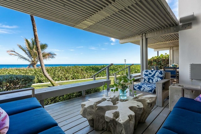 wooden deck with an outdoor hangout area and a water view