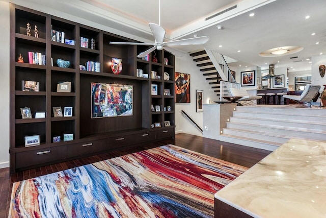 interior space featuring dark hardwood / wood-style floors, built in features, and ceiling fan