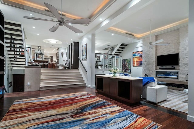 living room featuring dark wood-type flooring and ceiling fan