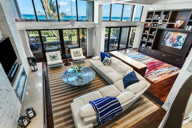 living room featuring ceiling fan and a towering ceiling