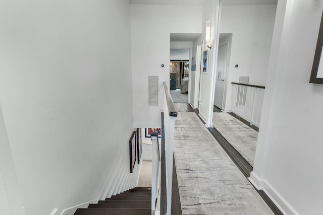 hallway with hardwood / wood-style flooring