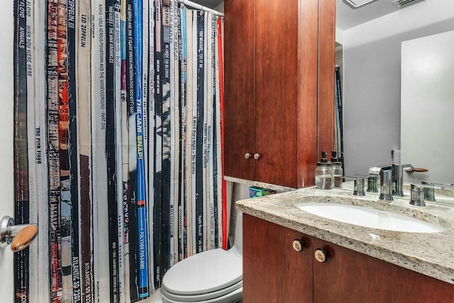 bathroom with vanity and toilet